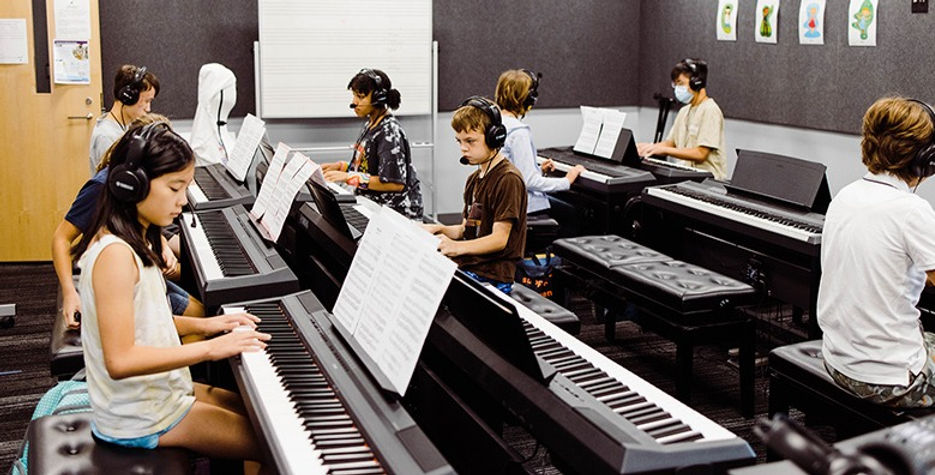 A group of people sitting at different keyboards.