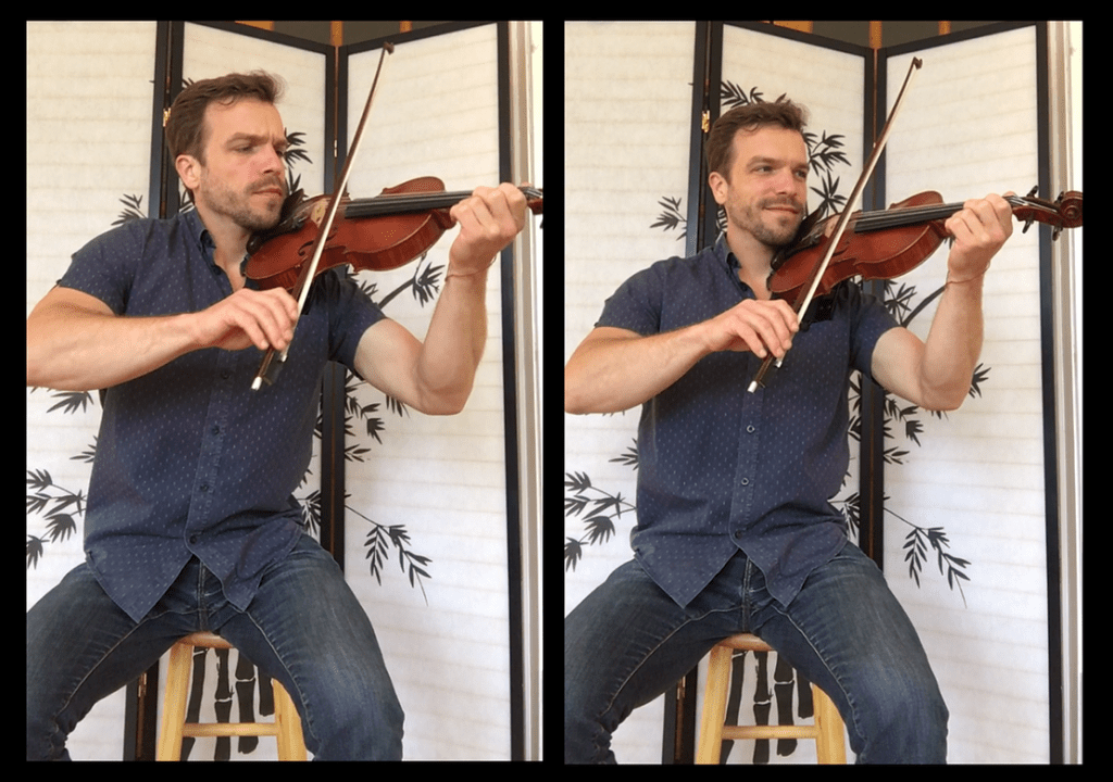 A man playing the violin in front of a screen.