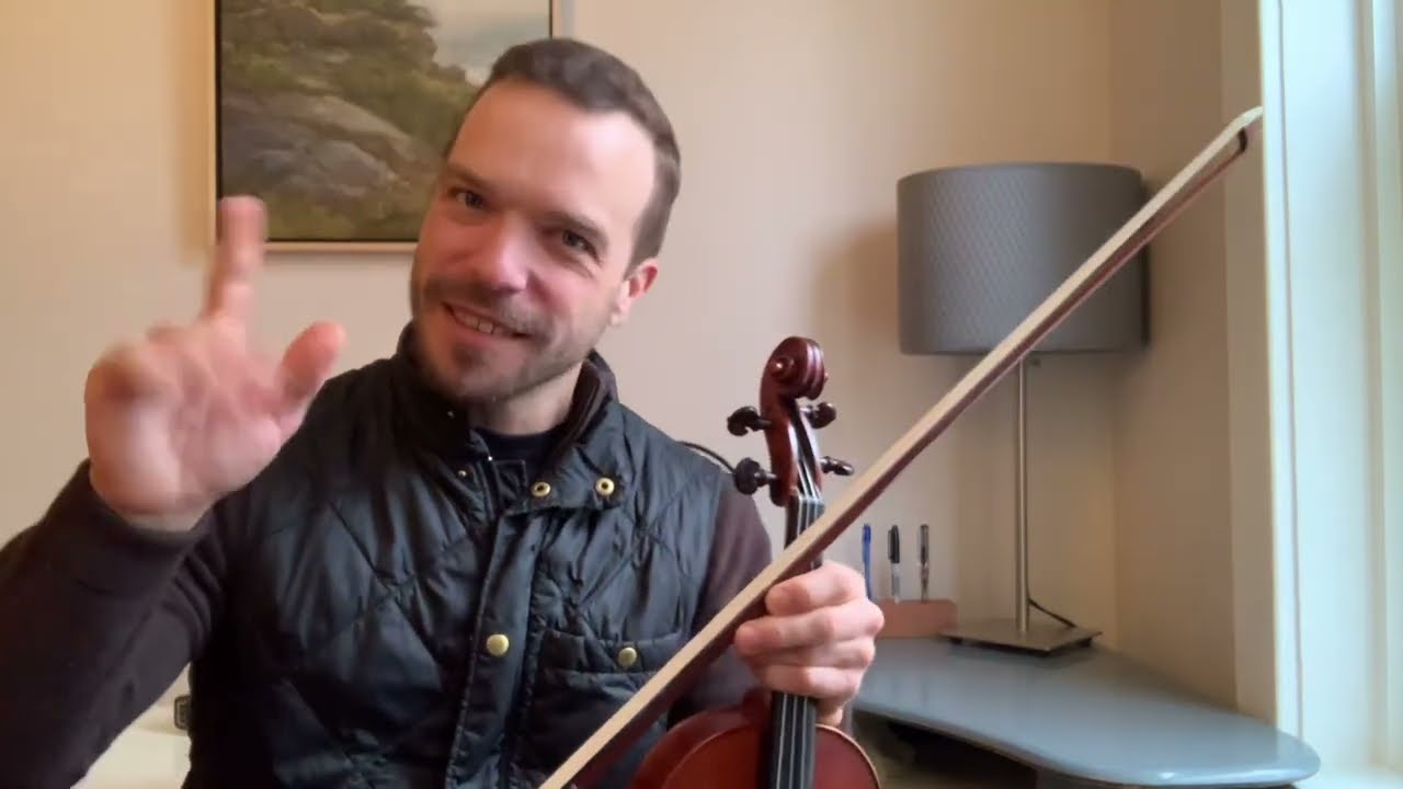 A man holding a violin in his hand.