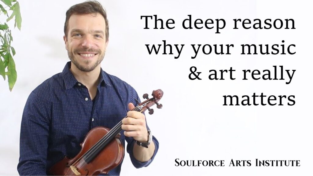 A man holding a violin with the words " soulforce art studio " on it.