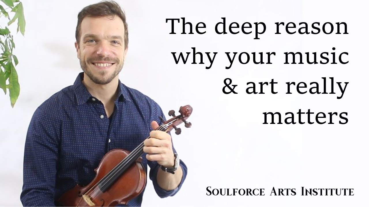 A man holding a violin with the words " soulforce art studio " on it.