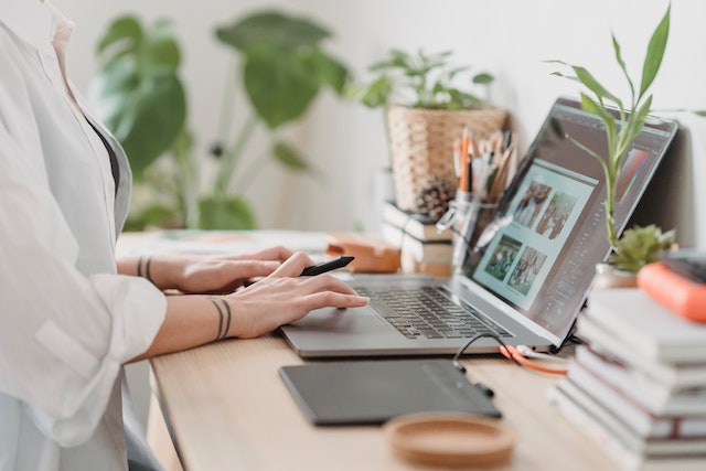 A person sitting at a desk with a laptop.